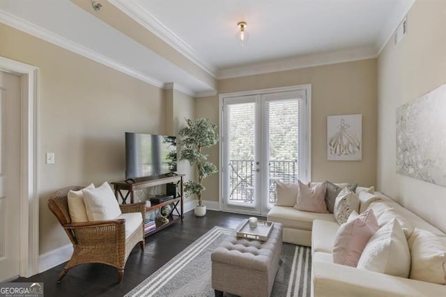 living room featuring dark hardwood / wood-style flooring, crown molding, and french doors