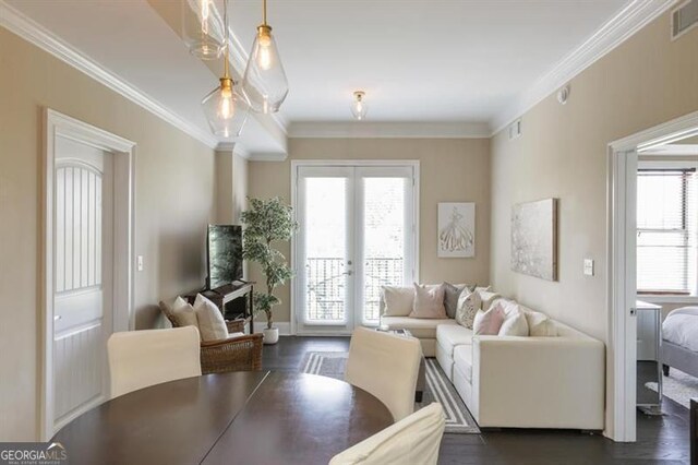 living area featuring dark wood-style floors, french doors, visible vents, and crown molding