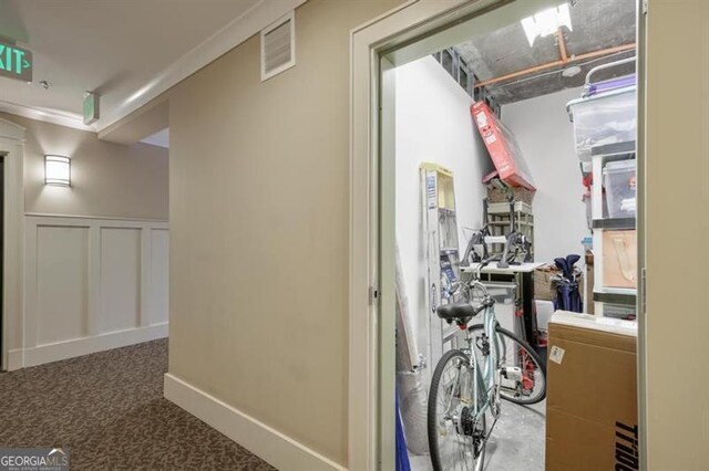 hall featuring crown molding and carpet floors