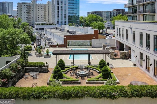 exterior space featuring a view of city and an outdoor fire pit