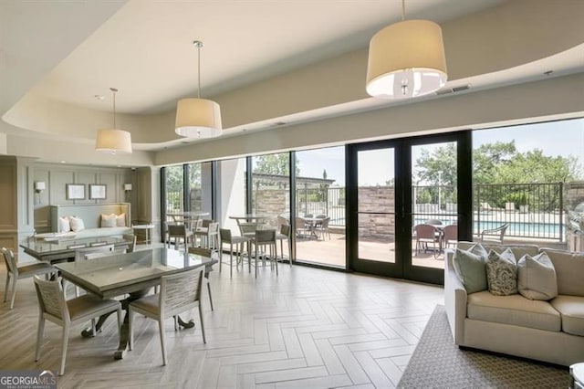 dining area with a towering ceiling and visible vents