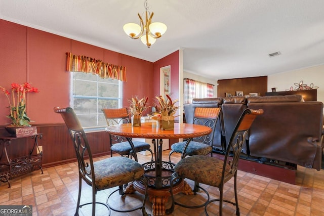 dining area with a healthy amount of sunlight and a notable chandelier