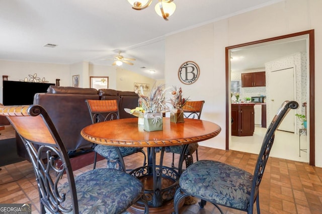 dining area featuring a wealth of natural light, ceiling fan, and lofted ceiling