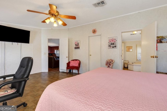 bedroom featuring ceiling fan, ornamental molding, and ensuite bath