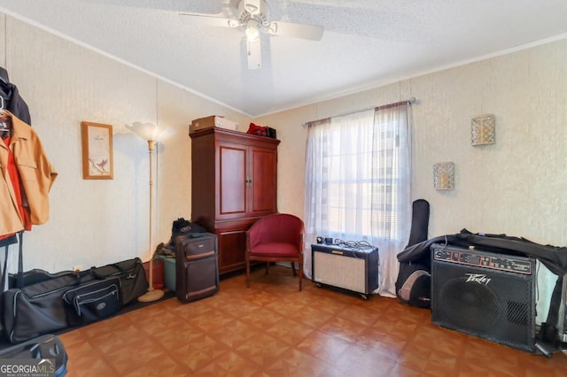 interior space featuring crown molding, ceiling fan, and a textured ceiling