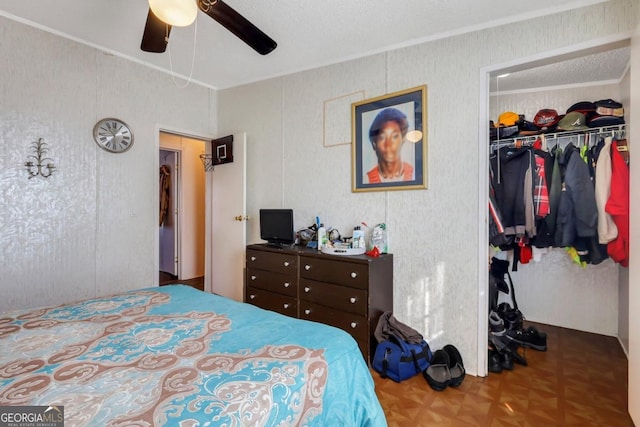 bedroom featuring ceiling fan, a closet, parquet floors, and a textured ceiling