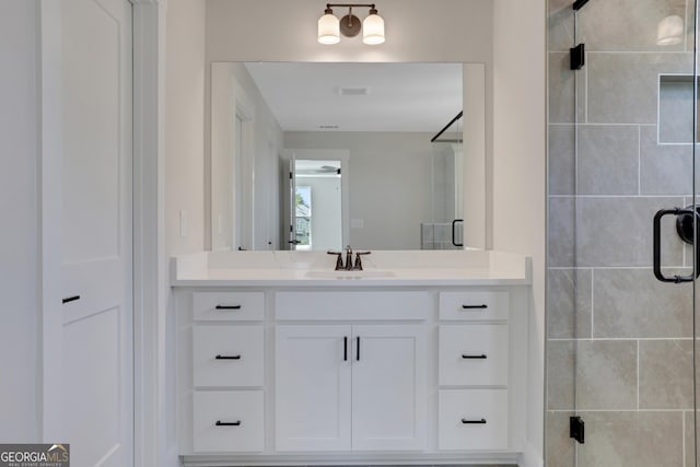 full bathroom featuring vanity, visible vents, and a shower stall