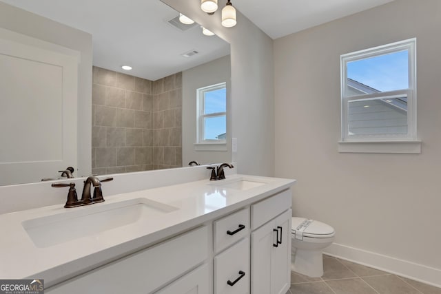 bathroom featuring tile patterned flooring, a sink, baseboards, and toilet