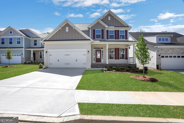 craftsman house with a front lawn, board and batten siding, driveway, and stone siding