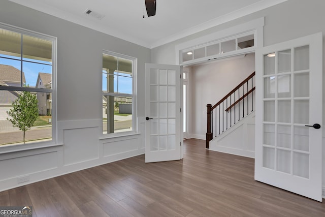 foyer with french doors, wood finished floors, a wealth of natural light, and visible vents