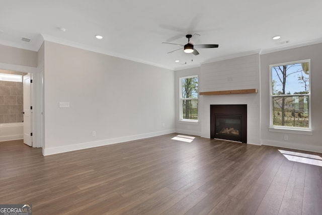 unfurnished living room with crown molding, a ceiling fan, visible vents, and a fireplace