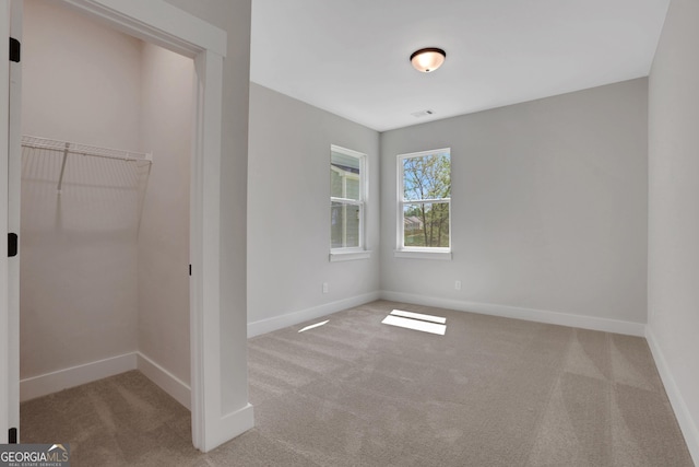 unfurnished bedroom featuring carpet floors and baseboards