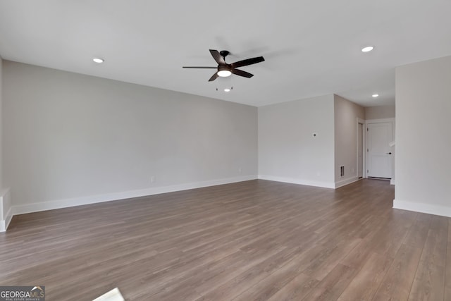 spare room featuring ceiling fan, visible vents, wood finished floors, baseboards, and recessed lighting