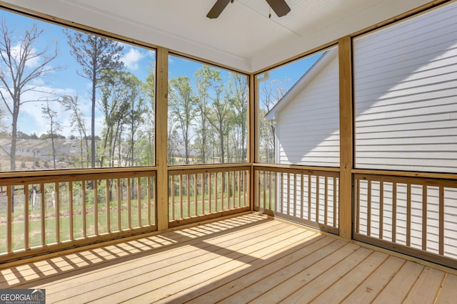 unfurnished sunroom featuring ceiling fan