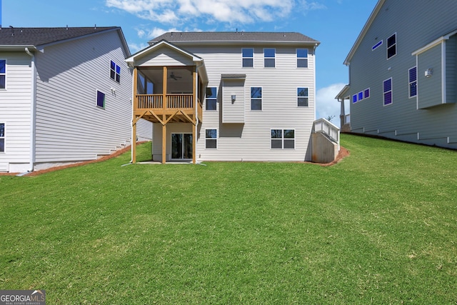 back of property featuring a lawn and ceiling fan