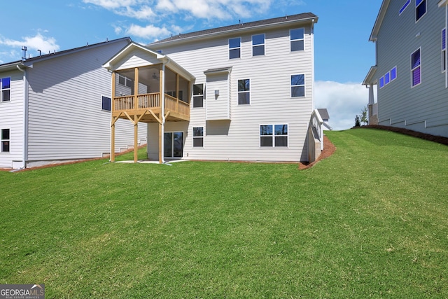 back of property with a sunroom, ceiling fan, and a yard