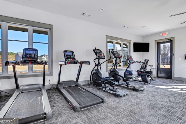 gym featuring carpet floors, baseboards, and visible vents