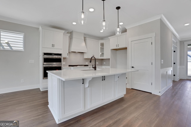 kitchen with custom range hood, dark wood finished floors, double oven, and white cabinetry