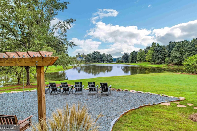 view of community with a lawn and a water view