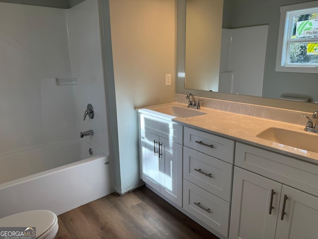 full bathroom with toilet, vanity, shower / bathtub combination, and hardwood / wood-style flooring