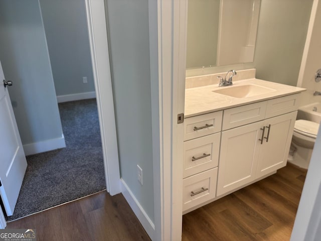 full bathroom with vanity, hardwood / wood-style flooring, toilet, and shower / bathtub combination