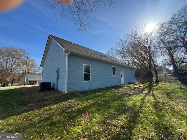 view of home's exterior featuring a yard and central AC