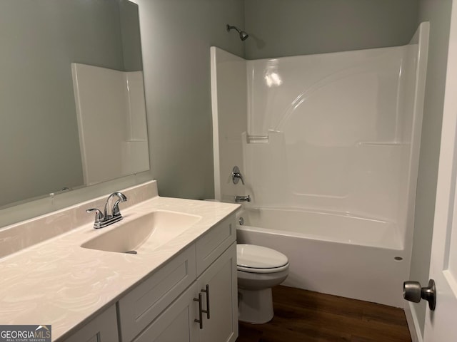 full bathroom featuring hardwood / wood-style flooring, vanity, toilet, and shower / tub combination