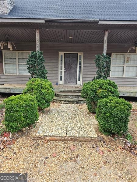 view of exterior entry with covered porch