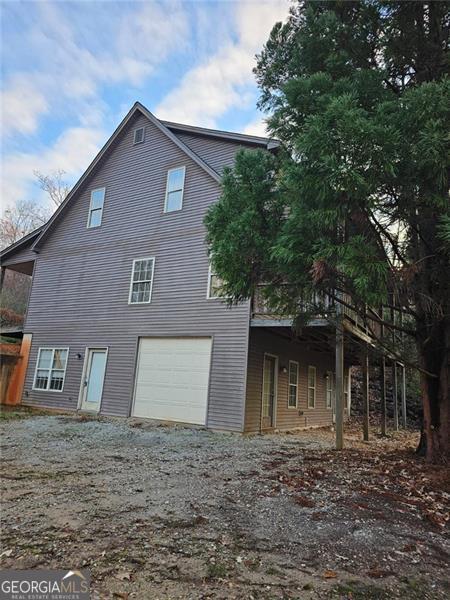 back of property with a garage