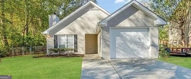 view of front of house with a front yard and a garage