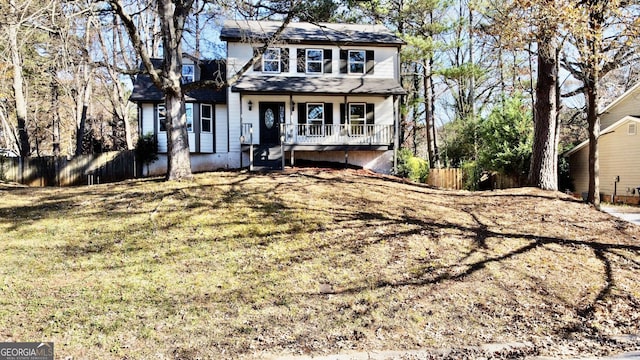 view of front of property featuring covered porch and a front lawn