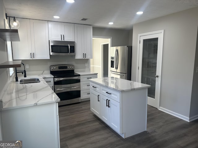 kitchen featuring white cabinetry, a center island, and appliances with stainless steel finishes