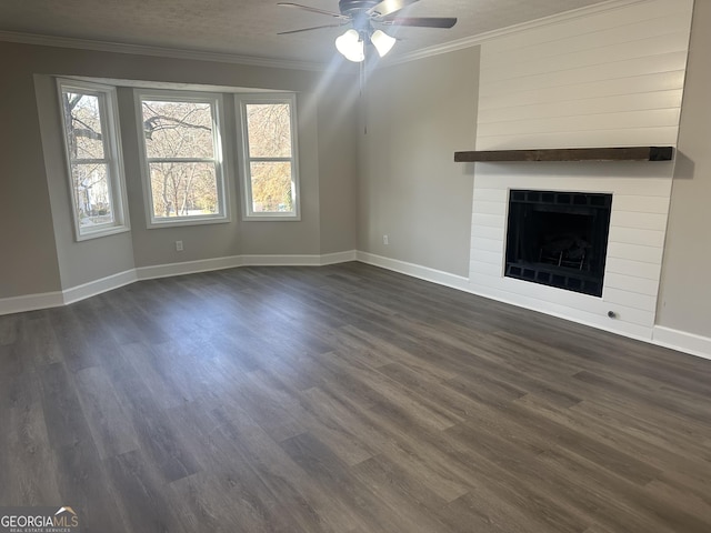 unfurnished living room with ornamental molding, a textured ceiling, ceiling fan, a fireplace, and dark hardwood / wood-style floors