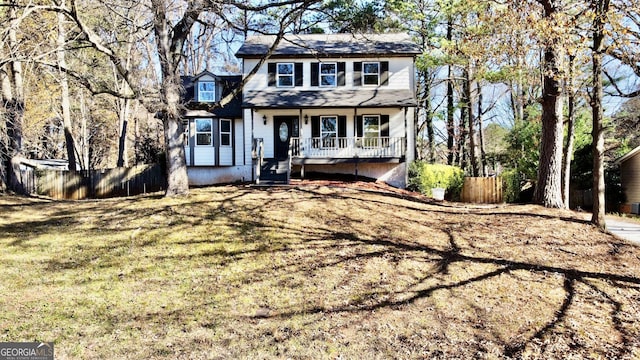 view of front of home with covered porch and a front yard