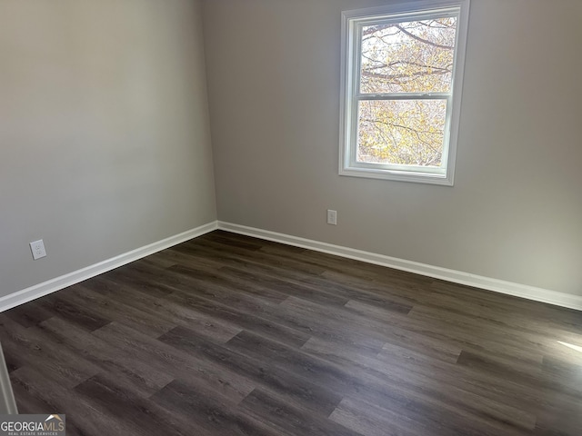 empty room featuring dark wood-type flooring