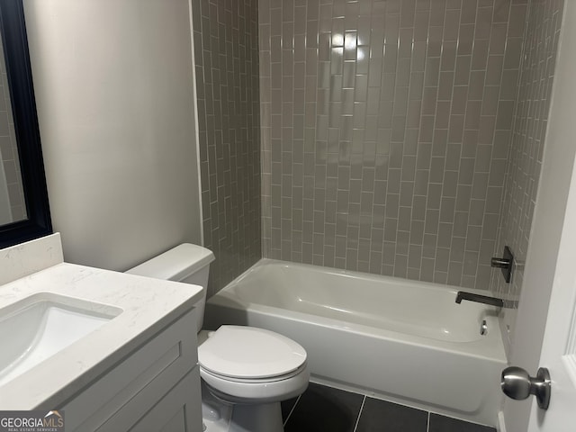 full bathroom with tile patterned flooring, tiled shower / bath combo, toilet, and vanity