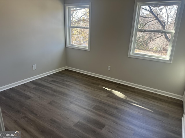 spare room with dark wood-type flooring