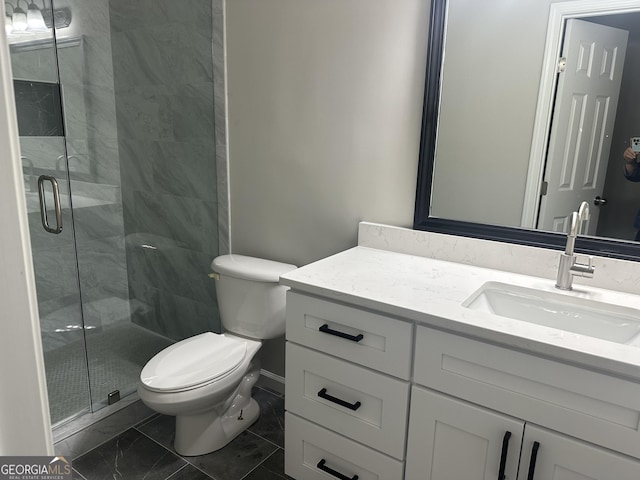 bathroom with vanity, a shower with shower door, and toilet