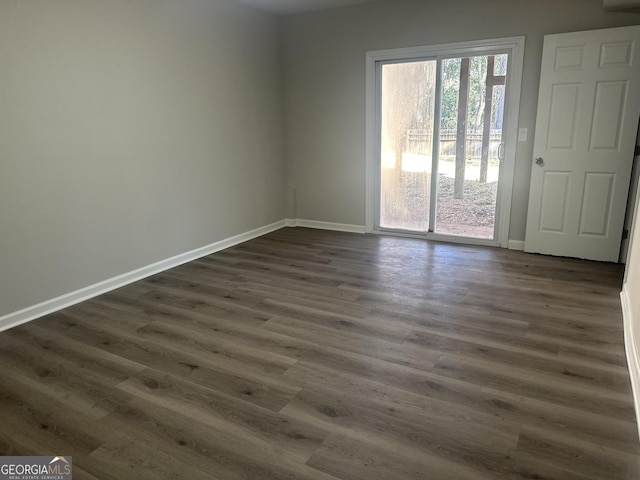 empty room with dark hardwood / wood-style floors