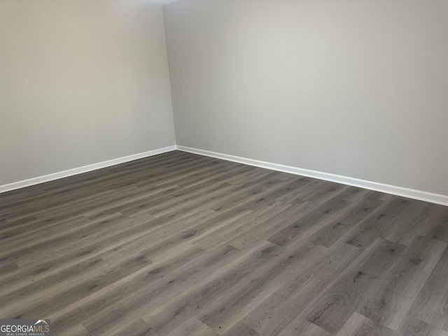 empty room featuring dark hardwood / wood-style flooring