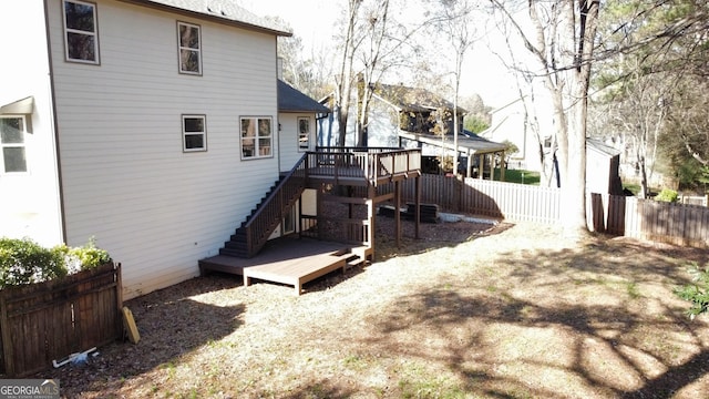 rear view of property featuring a wooden deck