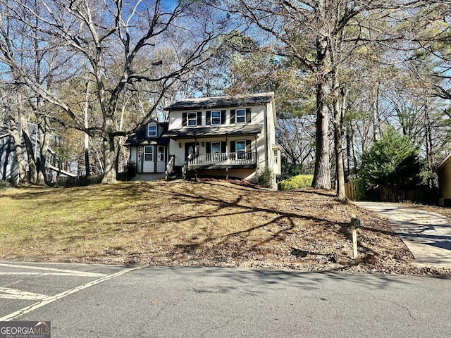 view of front property with a front yard and a porch