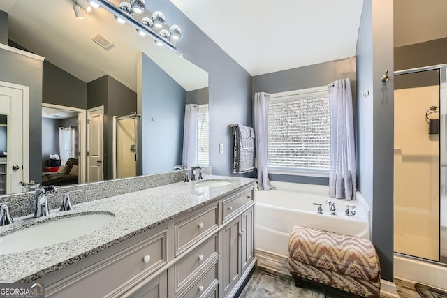 bathroom featuring vanity, plus walk in shower, and vaulted ceiling