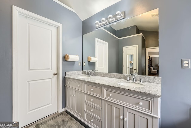 bathroom featuring vanity and vaulted ceiling