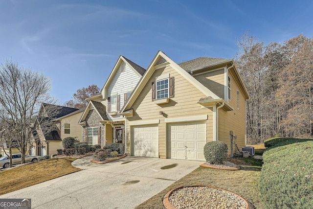 front of property with central AC unit and a garage