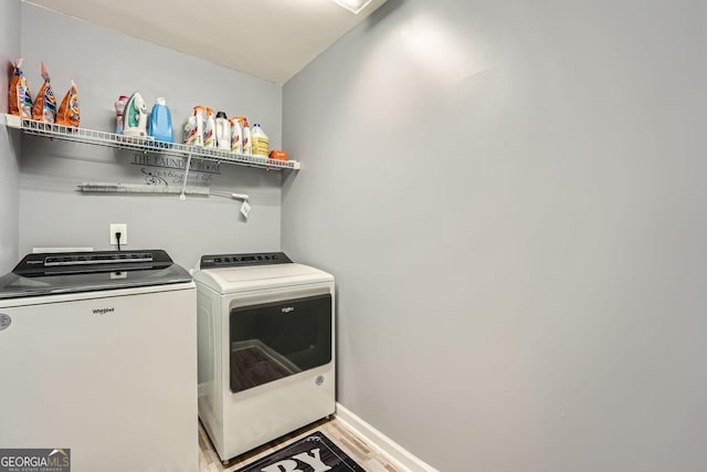 washroom with washer and dryer and hardwood / wood-style flooring