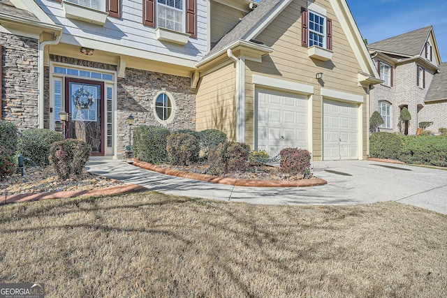 doorway to property with a garage