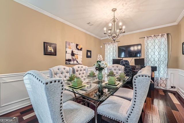 dining space with a notable chandelier, dark hardwood / wood-style floors, and ornamental molding