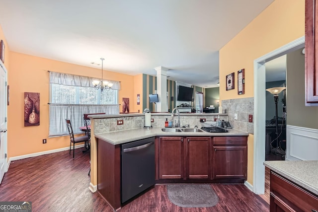 kitchen featuring dark hardwood / wood-style flooring, sink, pendant lighting, a notable chandelier, and dishwasher