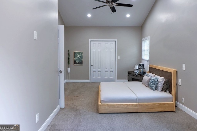 carpeted bedroom with ceiling fan and a closet